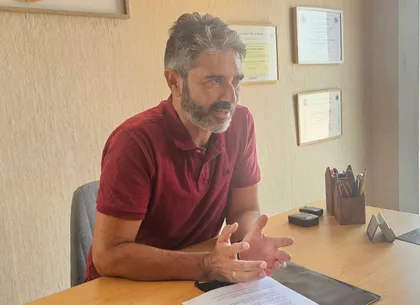 Jesús Martínez Martínez explicando algo sentado en su mesa de despacho